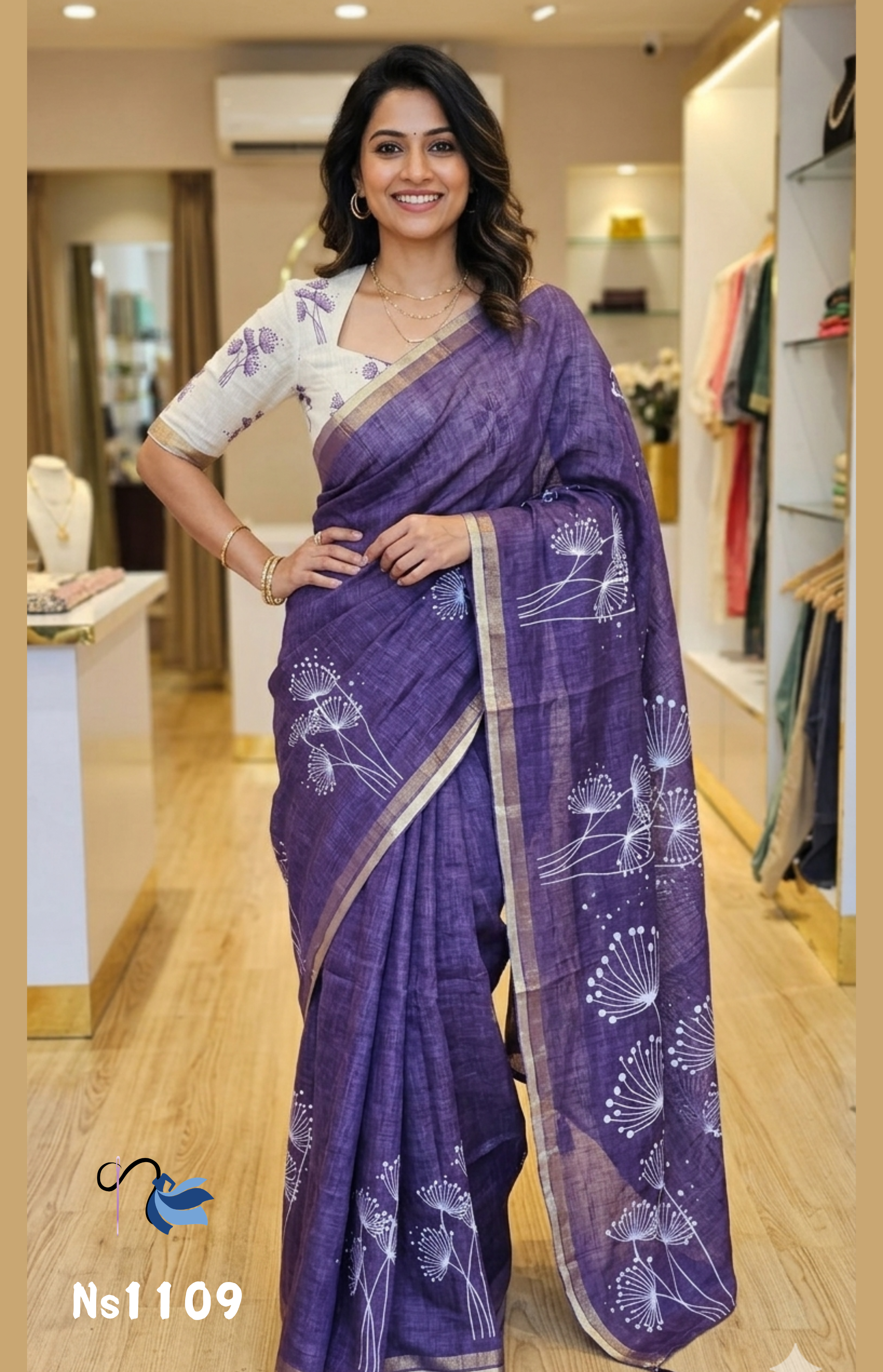 Model wearing a deep indigo purple linen cotton saree with white dandelion motifs and a gold border, paired with a cream printed blouse, part of the NAANAL Office Wear Series