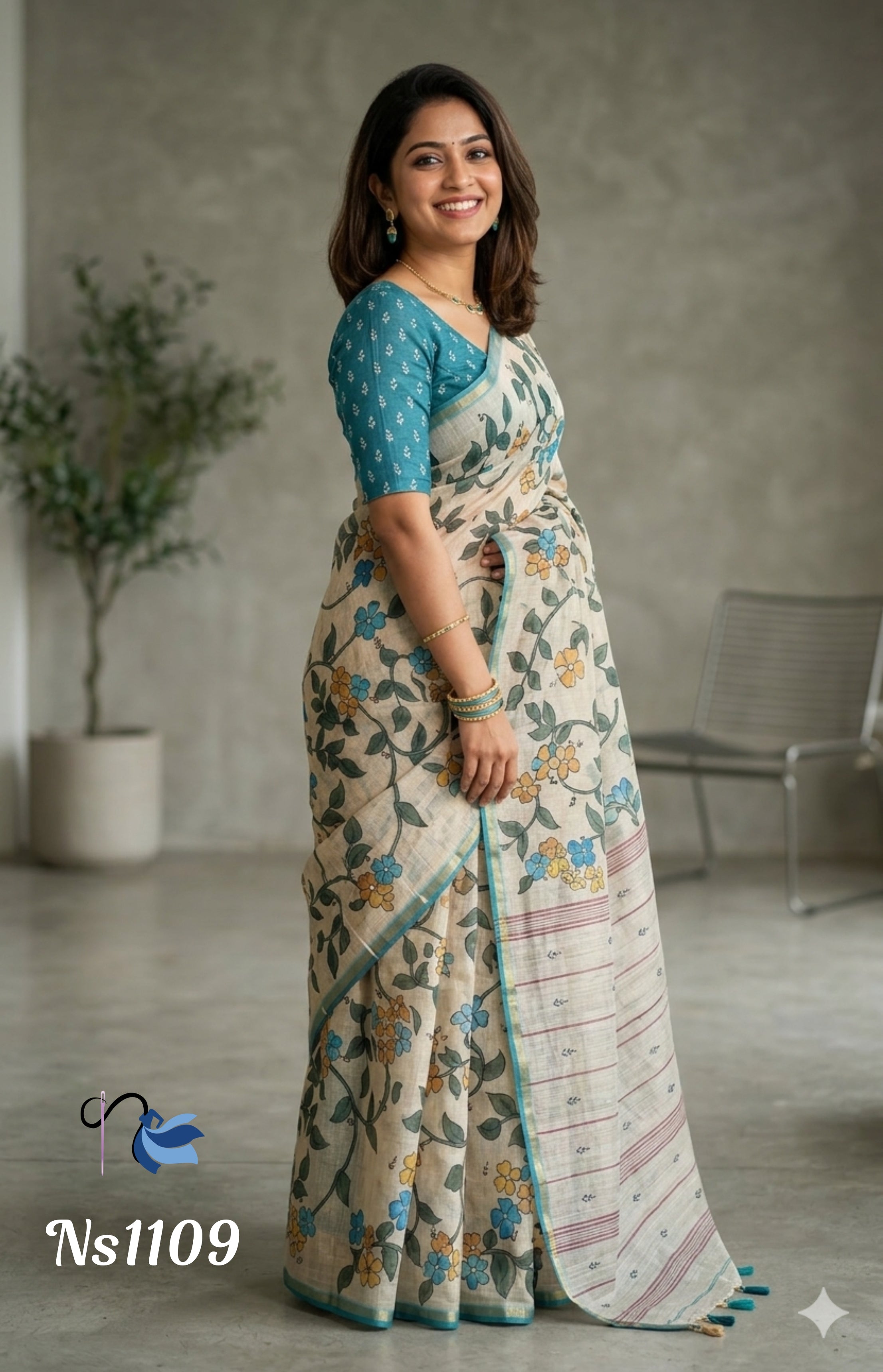 Woman wearing a floral saree with a blue blouse in an indoor setting