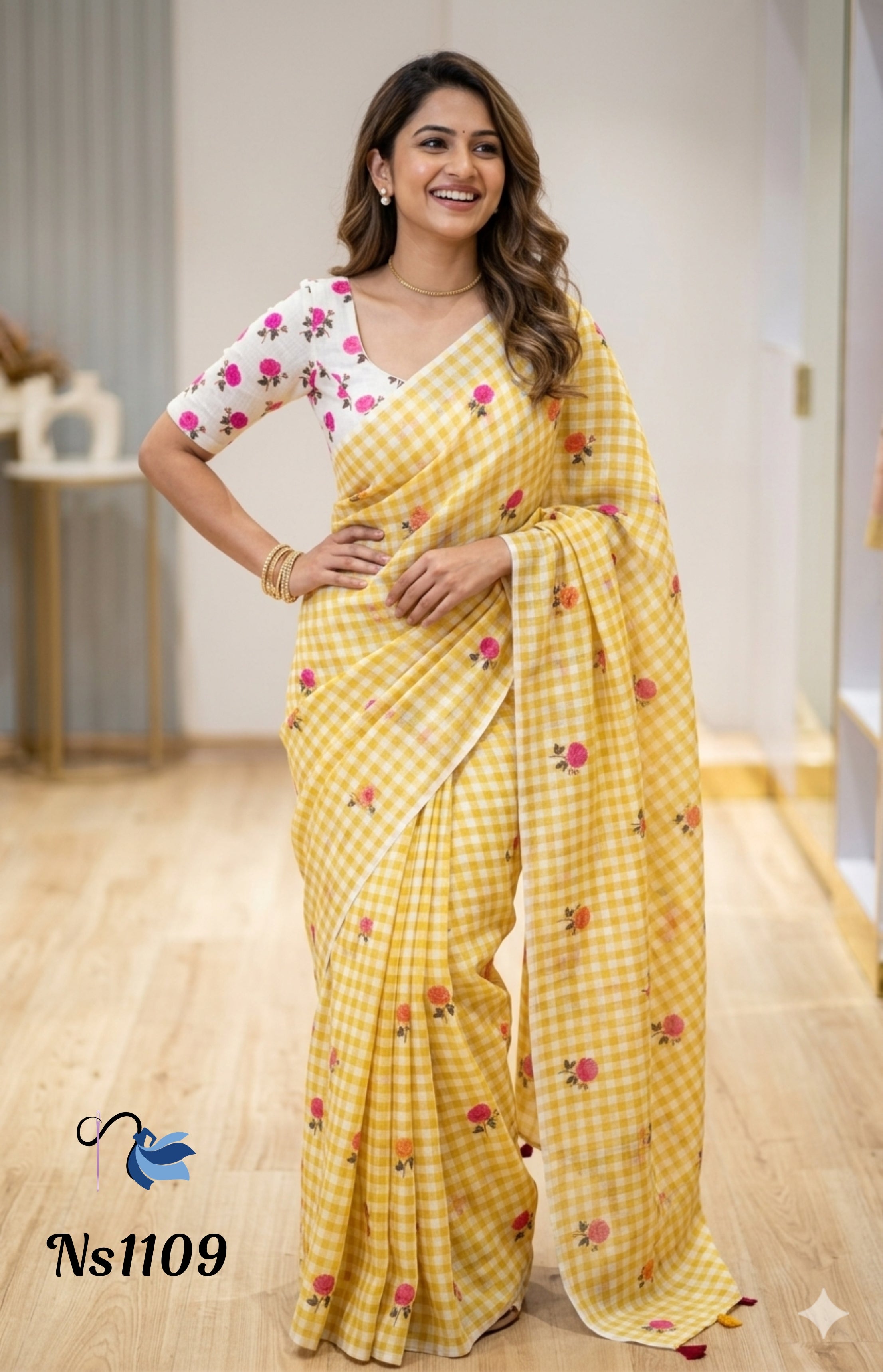 Model in a vibrant mustard yellow and white gingham checkered saree from Ns1109, decorated with pink and orange floral motifs and paired with a white floral blouse.