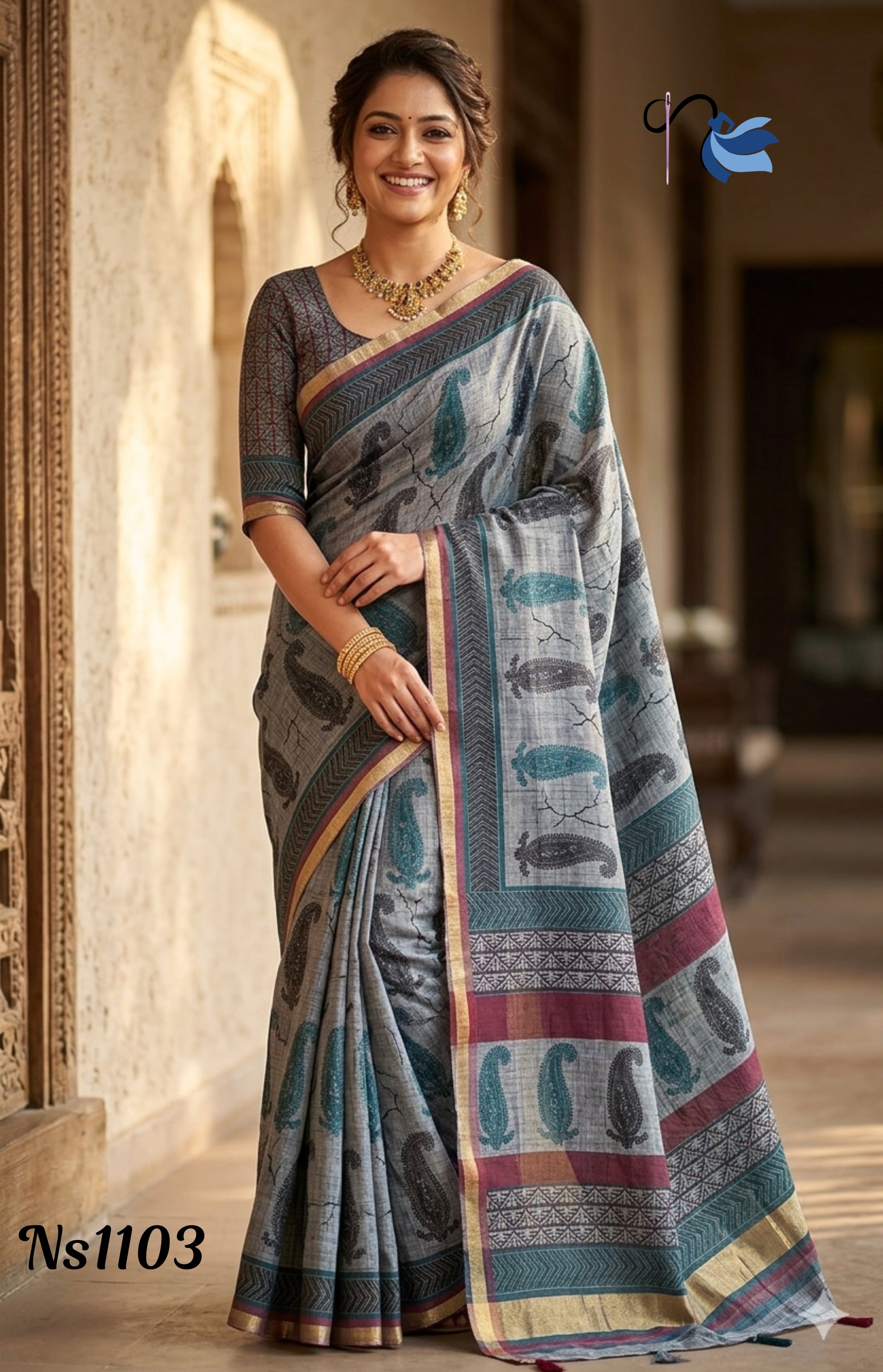 Woman wearing a traditional saree with a decorative pattern, standing indoors.